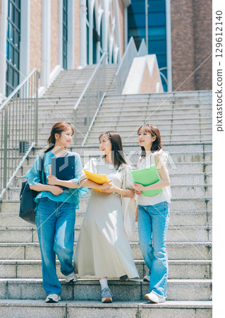 Three college students walking on campus Three college students walking on campus 129612140