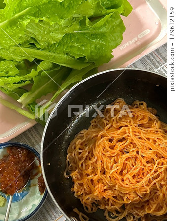 Spicy and tangy bibim guksu with chewy noodles, fresh veggies, and gochujang sauce. A vibrant and refreshing Korean cold noodle dish perfect for a light yet flavorful meal. Spicy and tangy bibim guksu with chewy noodles, fresh veggies, and gochujang sauce. A vibrant and refreshing Korean cold noodle dish perfect for a light yet flavorful meal. 129612159