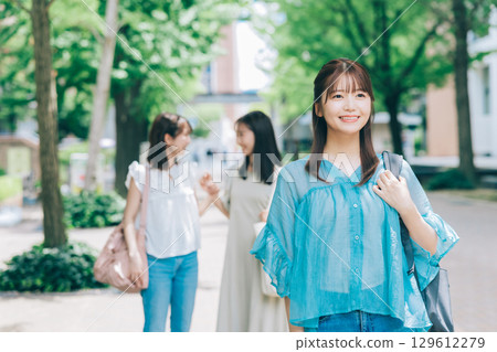 Female college student walking inside the university 129612279