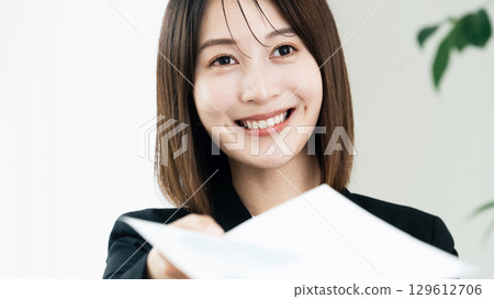 Business woman handing documents 129612706