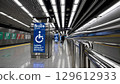 Accessible subway platform with braille signage, audio guidance, tactile paving, and guide rails supporting independent travel for visually impaired passengers 129612933
