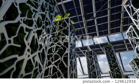 Innovative vertical farming system combines plant cultivation with renewable energy, maximizing efficiency and sustainability in food production 129612938