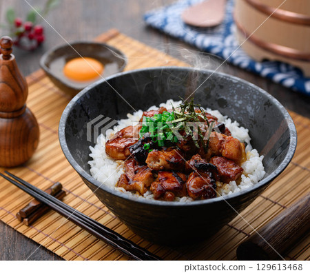A savory yakitori bowl with teriyaki sauce, hot rice and juicy chicken. Perfect for lunch, dinner, or as a promotional menu item. A savory yakitori bowl with teriyaki sauce, hot rice and juicy chicken. Perfect for lunch, dinner, or as a promotional menu item. 129613468