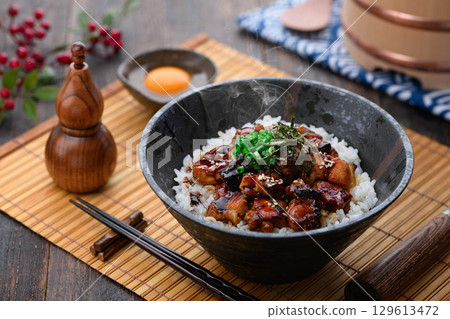 A savory yakitori bowl with teriyaki sauce, hot rice and juicy chicken. Perfect for lunch, dinner, or as a promotional menu item. 129613472