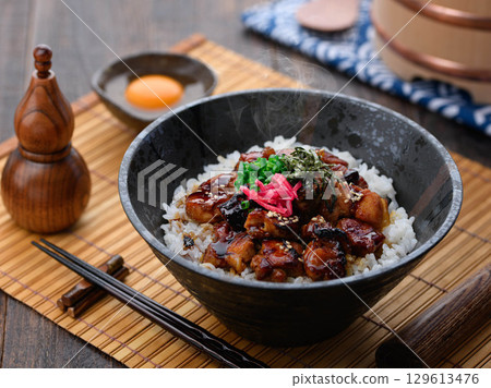 A savory yakitori bowl with teriyaki sauce, hot rice and juicy chicken. Perfect for lunch, dinner, or as a promotional menu item. 129613476