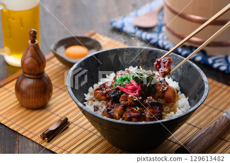 一碗美味的日式烤雞肉串，淋上照燒醬，配上熱騰騰的米飯和鮮嫩多汁的雞肉。非常適合午餐、晚餐，或作為促銷菜單的點心。 129613482