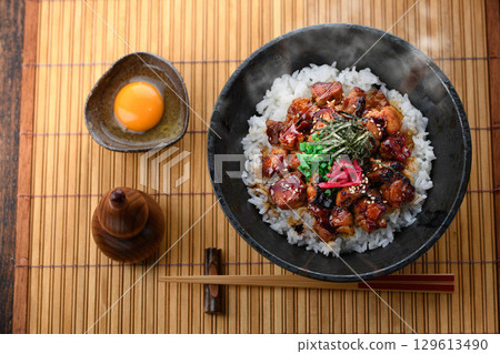 A savory yakitori bowl with teriyaki sauce, hot rice and juicy chicken. Perfect for lunch, dinner, or as a promotional menu item. 129613490
