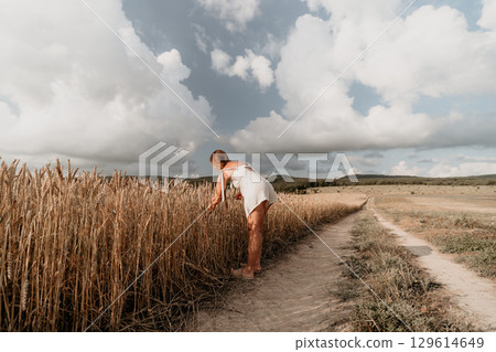 Woman in White Dress in Wheat Field Woman in White Dress in Wheat Field 129614649