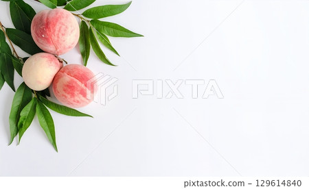 Fresh peaches with green leaves on white background 129614840