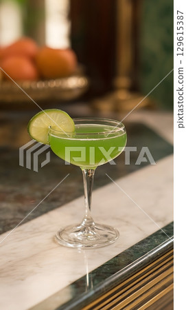 Refreshing Green Cocktail Garnished with a Slice of Lime. Refreshing Green Cocktail Garnished with a Slice of Lime. 129615387
