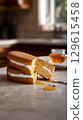 Delicious Honey Cake with Cream Filling Drizzling Sweetly. 129615458