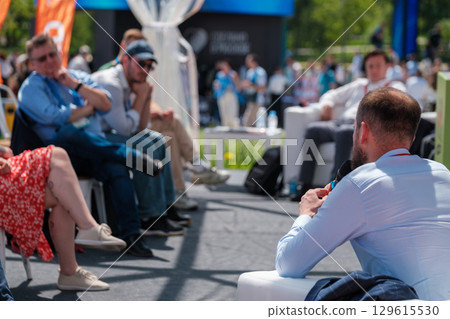 Outdoor discussion panel with audience in daylight during an event 129615530