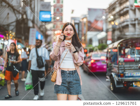 Happy adult asian traveler woman eating sweet taiwan boba dessert menu at Yaowarat road 129615701
