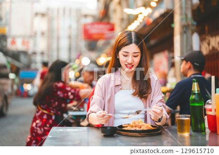 Traveler woman enjoy eating street food spicy thai tasty menu travel at chinatown Yaowarat, Bangkok Traveler woman enjoy eating street food spicy thai tasty menu travel at chinatown Yaowarat, Bangkok 129615710