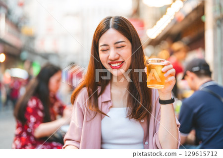 Young traveler woman eating street food spicy thai tasty menu travel at chinatown Yaowarat, Bangkok 129615712