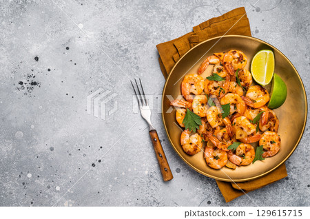 BBQ dinner with roast Shrimps Prawns in a plate. Gray background. Top view BBQ dinner with roast Shrimps Prawns in a plate. Gray background. Top view 129615715
