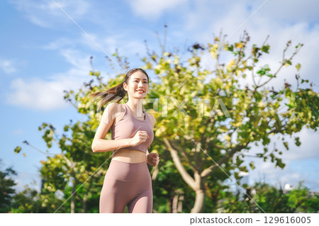 Asian exercise woman running at public park breathing fresh air wellness workout healthy lifestyle Asian exercise woman running at public park breathing fresh air wellness workout healthy lifestyle 129616005