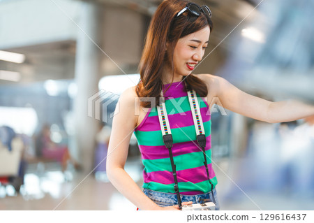 Asian woman consumer choosing food or seasoning product at supermarket store 129616437