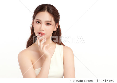 A beautiful young Asian woman with clean, fresh skin against a white background. Skincare, facial treatment, cosmetology, beauty, and spa. An elegant portrait of an Asian woman. 129616469