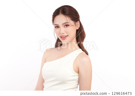 A beautiful young Asian woman with clean, fresh skin against a white background. Skincare, facial treatment, cosmetology, beauty, and spa. An elegant portrait of an Asian woman. A beautiful young Asian woman with clean, fresh skin against a white background. Skincare, facial treatment, cosmetology, beauty, and spa. An elegant portrait of an Asian woman. 129616473
