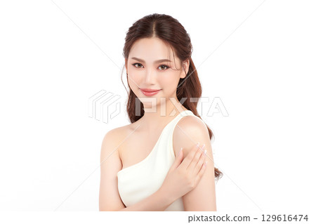 A beautiful young Asian woman with clean, fresh skin against a white background. Skincare, facial treatment, cosmetology, beauty, and spa. An elegant portrait of an Asian woman. A beautiful young Asian woman with clean, fresh skin against a white background. Skincare, facial treatment, cosmetology, beauty, and spa. An elegant portrait of an Asian woman. 129616474