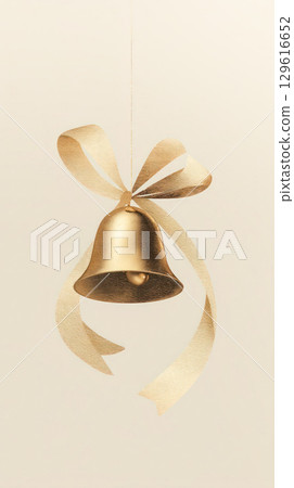 Golden decorative bell with elegant ribbon hanging against a soft neutral background, symbolizing celebration and festive occasions 129616652