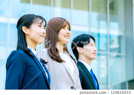 A business woman standing in an office town A business woman standing in an office town 129616833