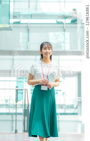 Thinking young woman holding a file 129616861