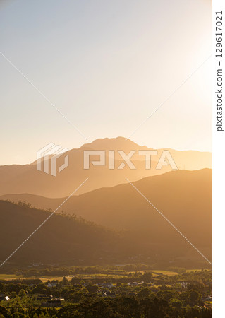 Mountains in sunset light. Golden hour, natural landscape with tonal perspective Mountains in sunset light. Golden hour, natural landscape with tonal perspective 129617021