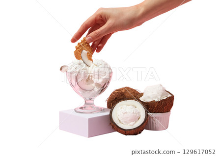 Scoop of coconut ice cream topped with cookie, isolated on white, PNG 129617052
