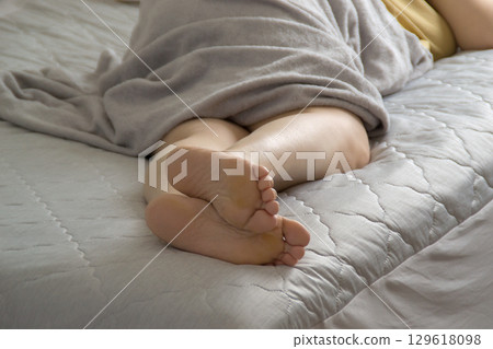 A woman taking a nap on a cooling sheet 129618098