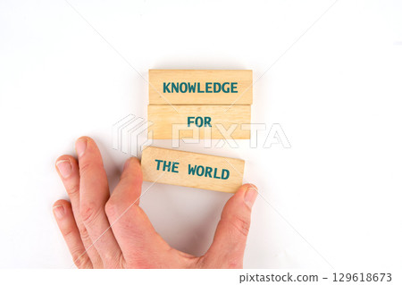 Business, success, idea, learning, planning, Education concept. KNOWLEDGE FOR THE WORLD made from blocks by hand on a light background, top view 129618673