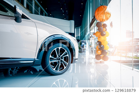 Car parked in luxury showroom. Car dealership office. Car showroom business. New car parked in modern showroom. Auto for sale and rent business. Automobile leasing and insurance. Electric automobile. 129618879