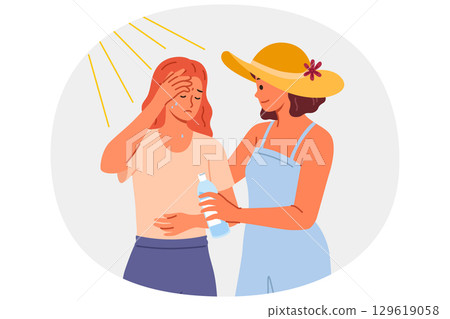 Woman who suffered sunstroke in hot weather stands near friend with bottle of water in hands Woman who suffered sunstroke in hot weather stands near friend with bottle of water in hands 129619058