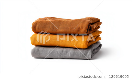 A stack of folded natural linen fabrics in an autumn color palette 129619095