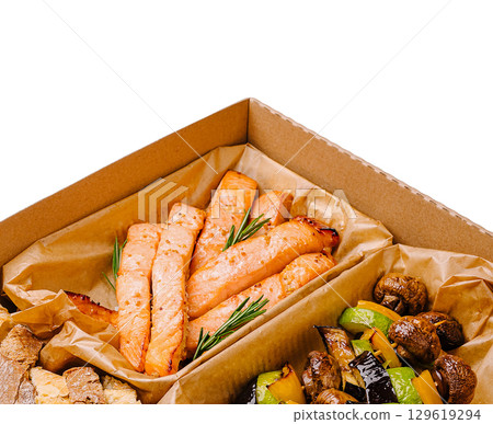 Salmon fillets and grilled vegetables in a takeout box from a restaurant Salmon fillets and grilled vegetables in a takeout box from a restaurant 129619294