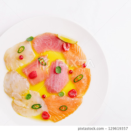 Colorful seafood platter featuring assorted fish and garnishes 129619357