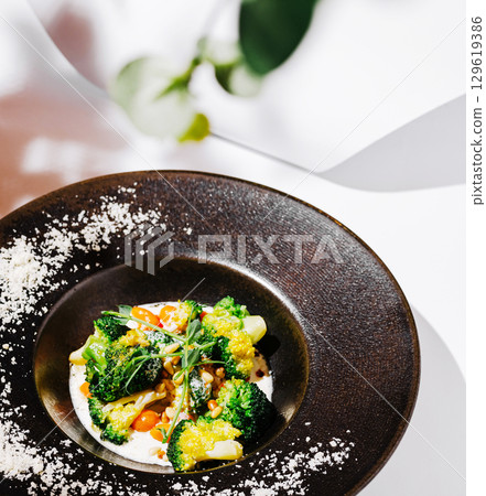 Freshly prepared vegetable dish served in a modern restaurant setting 129619386