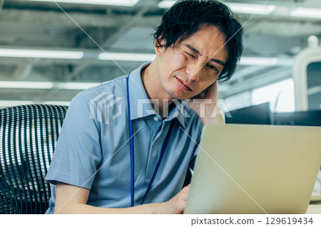 A man who is worried while looking at a computer 129619434