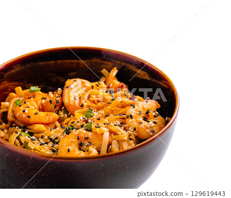 Flavorful shrimp noodles served warm in a stylish bowl during dinner time 129619443