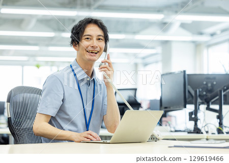 A businessman calling in the office A businessman calling in the office 129619466
