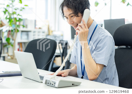 Telephone answering businessman Telephone answering businessman 129619468