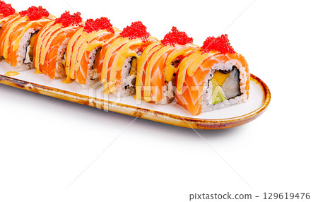 Sushi roll with salmon, avocado, and spicy mayo served on a plate Sushi roll with salmon, avocado, and spicy mayo served on a plate 129619476