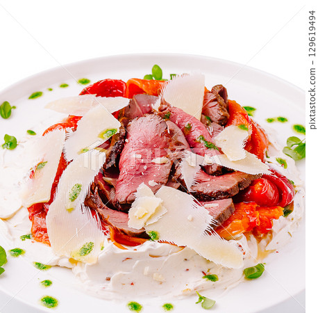 Savory beef dish with fresh ingredients and a creamy sauce Savory beef dish with fresh ingredients and a creamy sauce 129619494