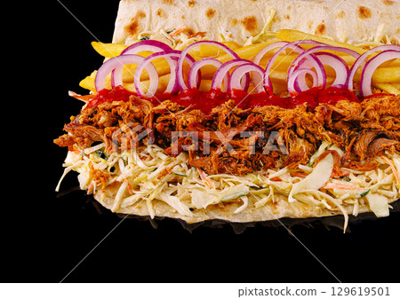 Tasty street food with shredded meat and fresh toppings on flatbread Tasty street food with shredded meat and fresh toppings on flatbread 129619501