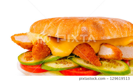 Delicious chicken sandwich with fresh vegetables and melted cheese on bread 129619513