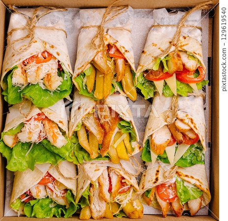 Delicious wraps filled with fresh ingredients ready for a tasty meal Delicious wraps filled with fresh ingredients ready for a tasty meal 129619540
