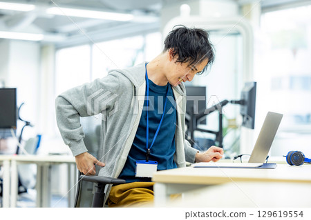 Lower back pain male office 129619554