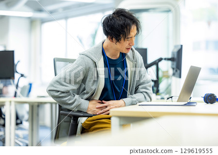 Lower back pain male office Lower back pain male office 129619555