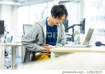 Lower back pain male office Lower back pain male office 129619557